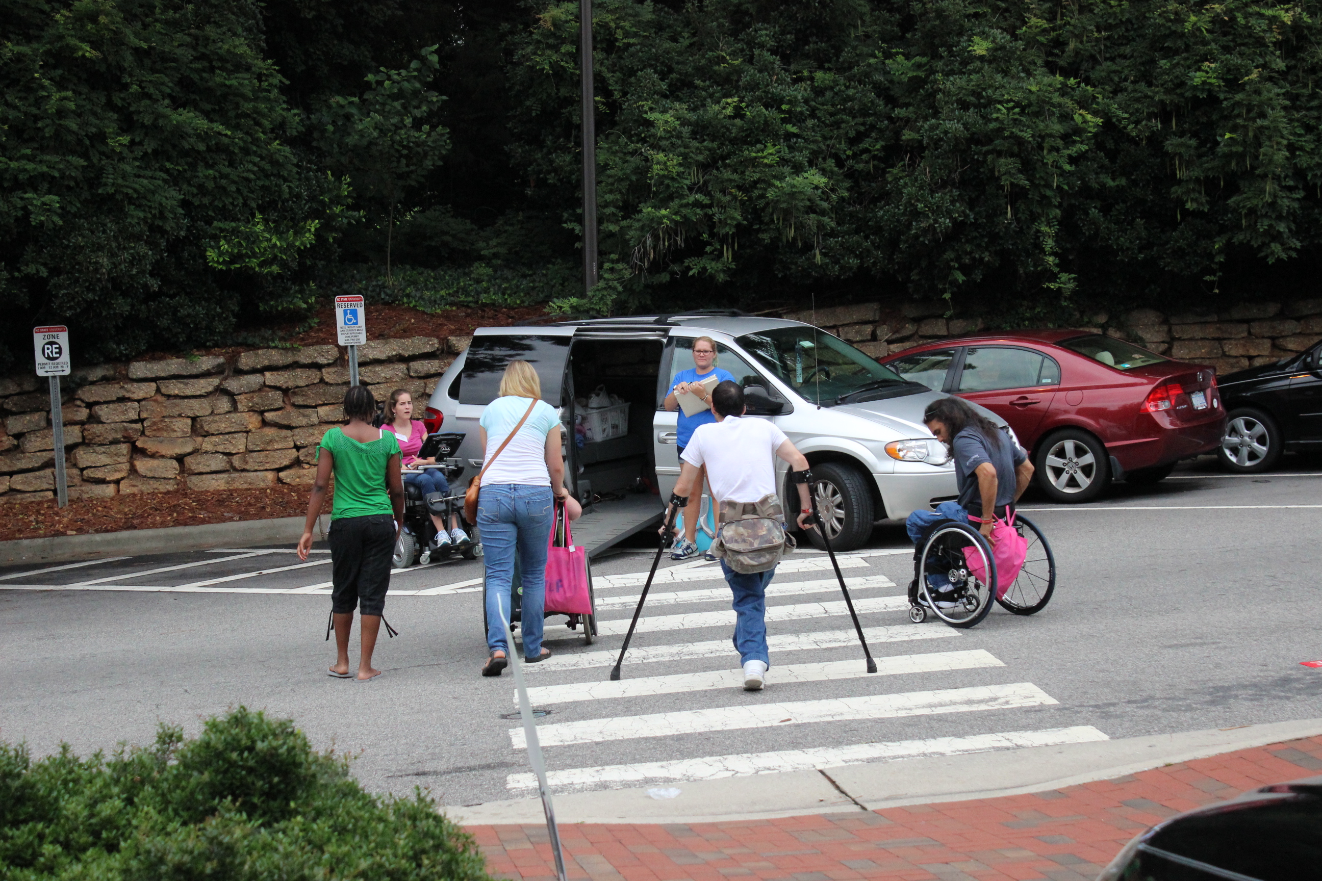 Riders approach a paratransit minivan