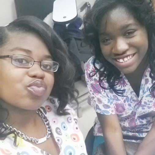 Autumn (right) and Destiny (left) while working together in the clinic for the Peer Educator program.