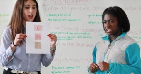 Autumn (right) and Brynne Presser Funderburg (left) as captured in a photo by the Cleveland Plain Dealer during a Peer Educator Program.