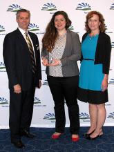 Hallie Foster (Center) receives award presented by Alan Morgan (left) and Lisa Kilawee (right).
