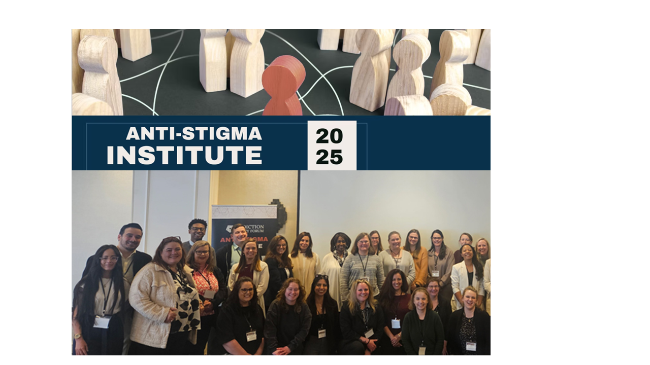 Ashley Wilson sitting in the front row of conference participants under the conference banner.