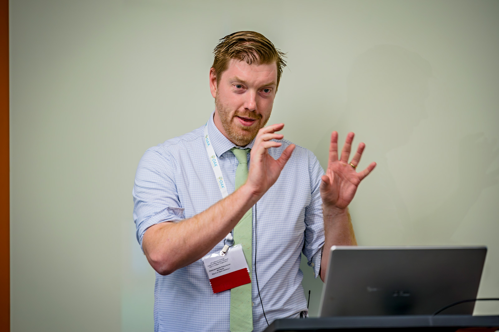 Robert Ashmead presenting in front of a podium and laptop
