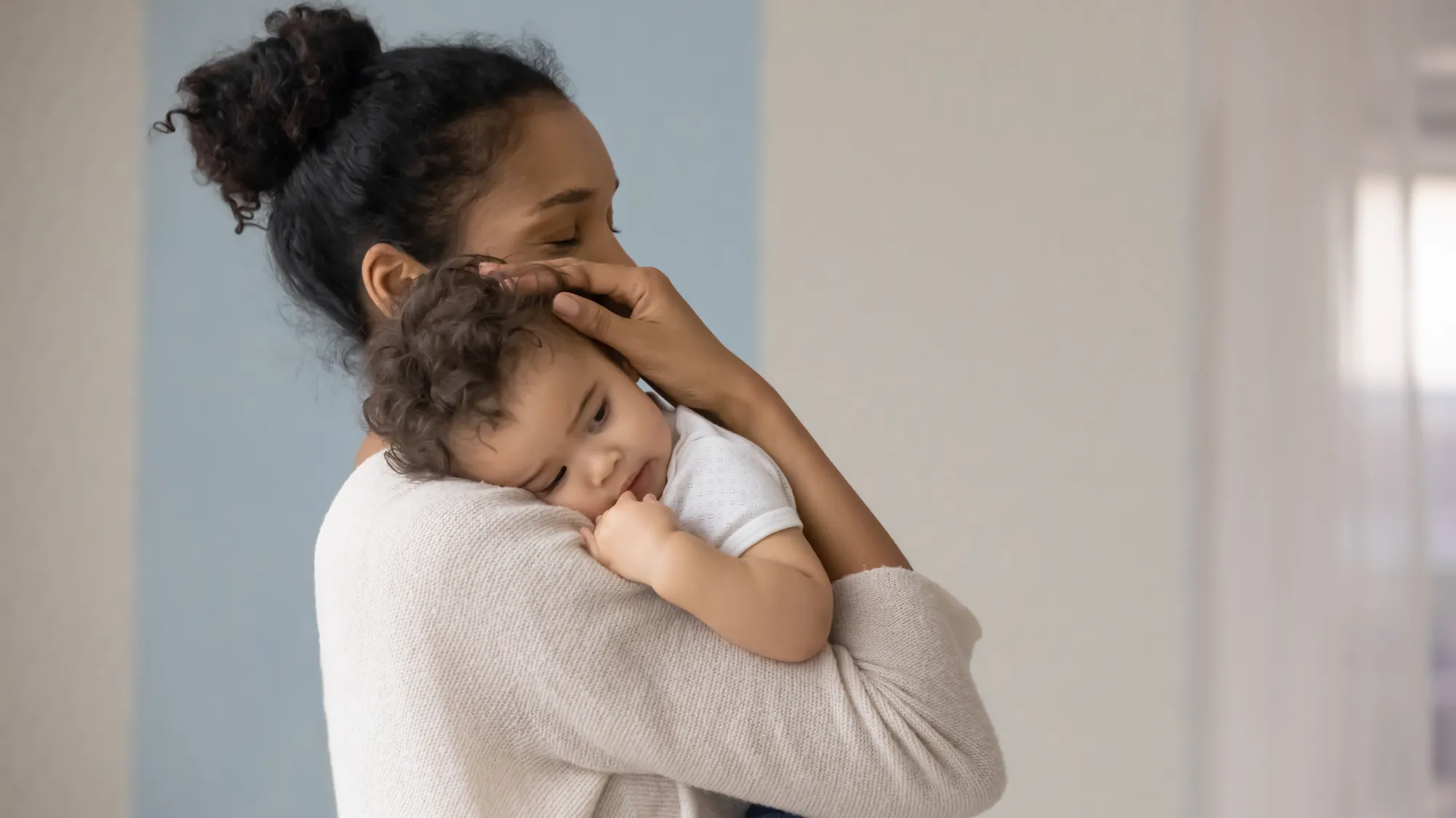 A mom holding her baby to her chest 